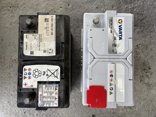 メルセデスベンツBクラス 補機バッテリー交換 修理で取り外した旧バッテリーと新品VARTA製AGMバッテリー 取り外した純正補機バッテリー(黒色)と、新品VARTA製AGM補機バッテリー(白色)を並べた比較写真。
劣化した旧バッテリーと新品部品の違いが分かる構図。