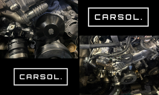 BMW 320dのエンジンルームでウォーターポンプ周辺の部品を取り外し、冷却水漏れ修理の作業を行っている様子