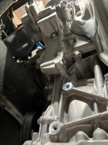 VW ザ・ビートルのオイルエレメントハウジング周辺を取り外した状態で、ガスケット交換後の取付面とエンジン側を確認している整備中の様子